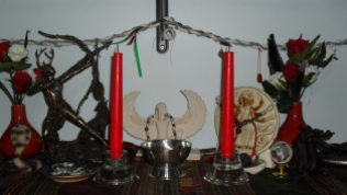 I still need more for Isis, but this is the central part of the shrine. Isis has the central part, and Hekate has the space to the right. Also because the cingulum has a little Isian charm sitting just above where Isis' statue is. I also just made Her some prayer beads, so those are sitting on Her statue as well. The silver bowl is a libation/offering bowl.
