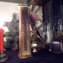 Hestia's candle is just to the right of the tower incense burner, and Gaia is hiding behind there as well. There is never enough light over here.